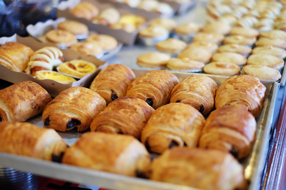 Freshly baked croissants resting on a wire cooling rack
