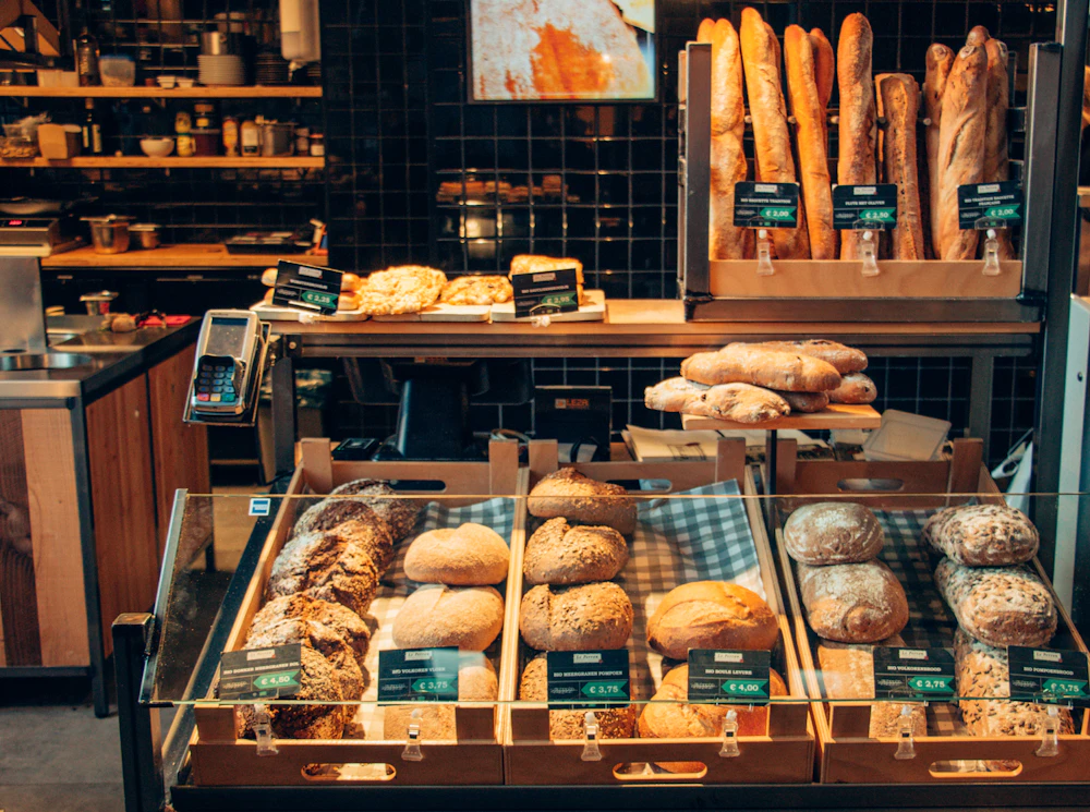 Inside the Golden Crust bakery with a glass display case full of fresh pastries