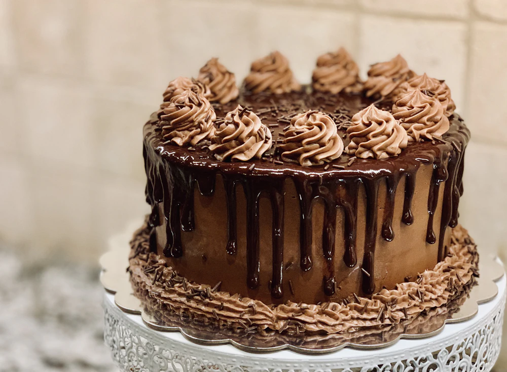 Hand-finished celebration cake with smooth buttercream and piping details
